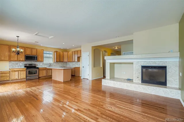 a view of kitchen with wooden floor and fireplace