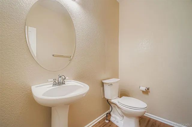 a bathroom with a sink toilet and a mirror