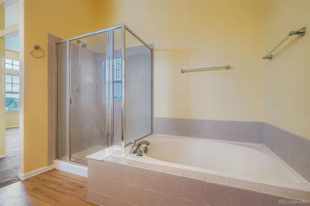 a bathroom with a tub and shower