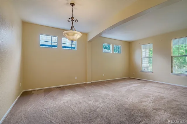 a view of an empty room with windows