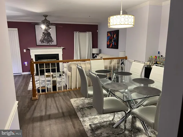 a view of a dining room with furniture wooden floor and chandelier