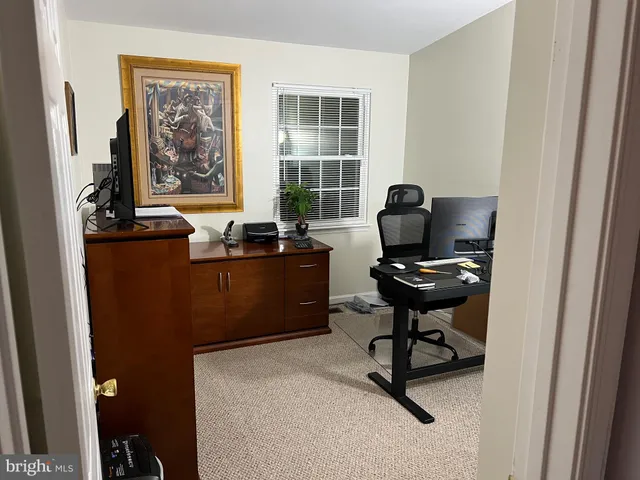 a living room with furniture and stairs