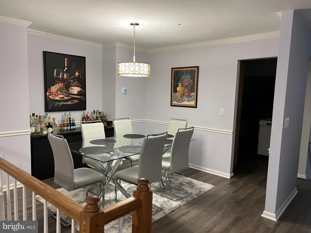 a view of a dining room with furniture wooden floor and chandelier