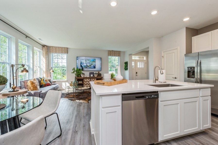 1218 Draper Road McHenry, IL 60050 - Photo 3 of 30 a kitchen with sink stove and white cabinets with wooden floor