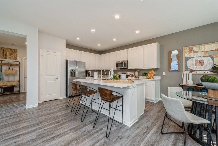 1218 Draper Road McHenry, IL 60050 - Photo 5 of 30 a kitchen with a table and chairs in it