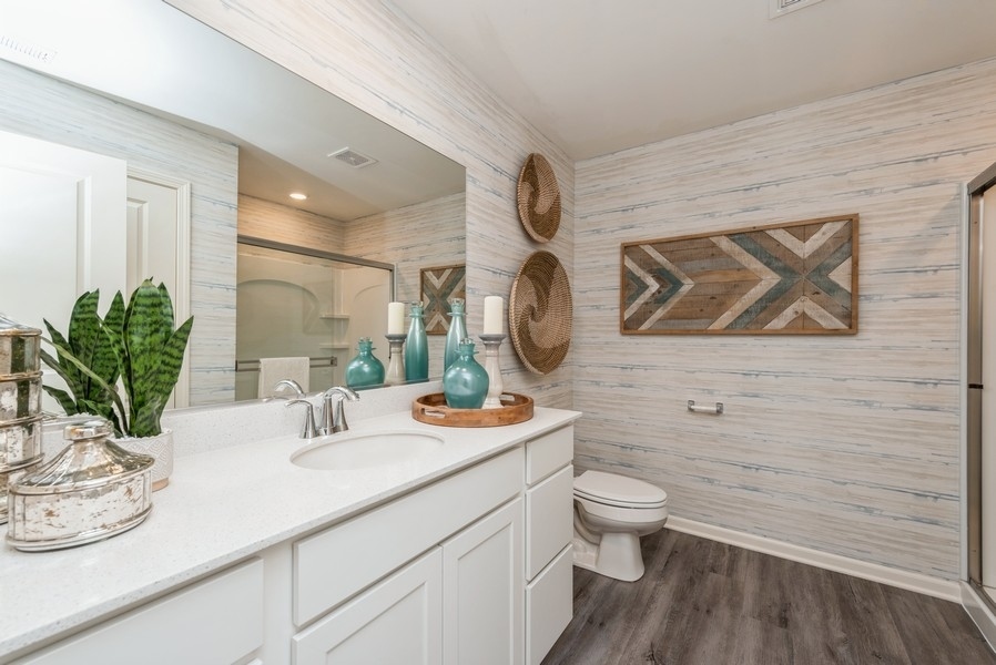 1218 Draper Road McHenry, IL 60050 - Photo 10 of 30 a bathroom with a granite countertop sink mirror vanity and toilet