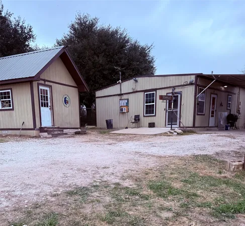 front view of house with a yard and car parked