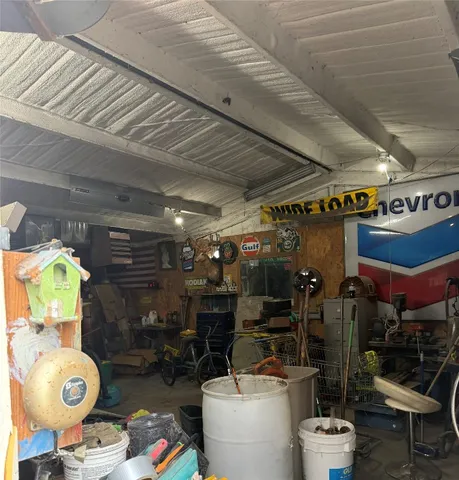 a view of an empty room with a fireplace and a window