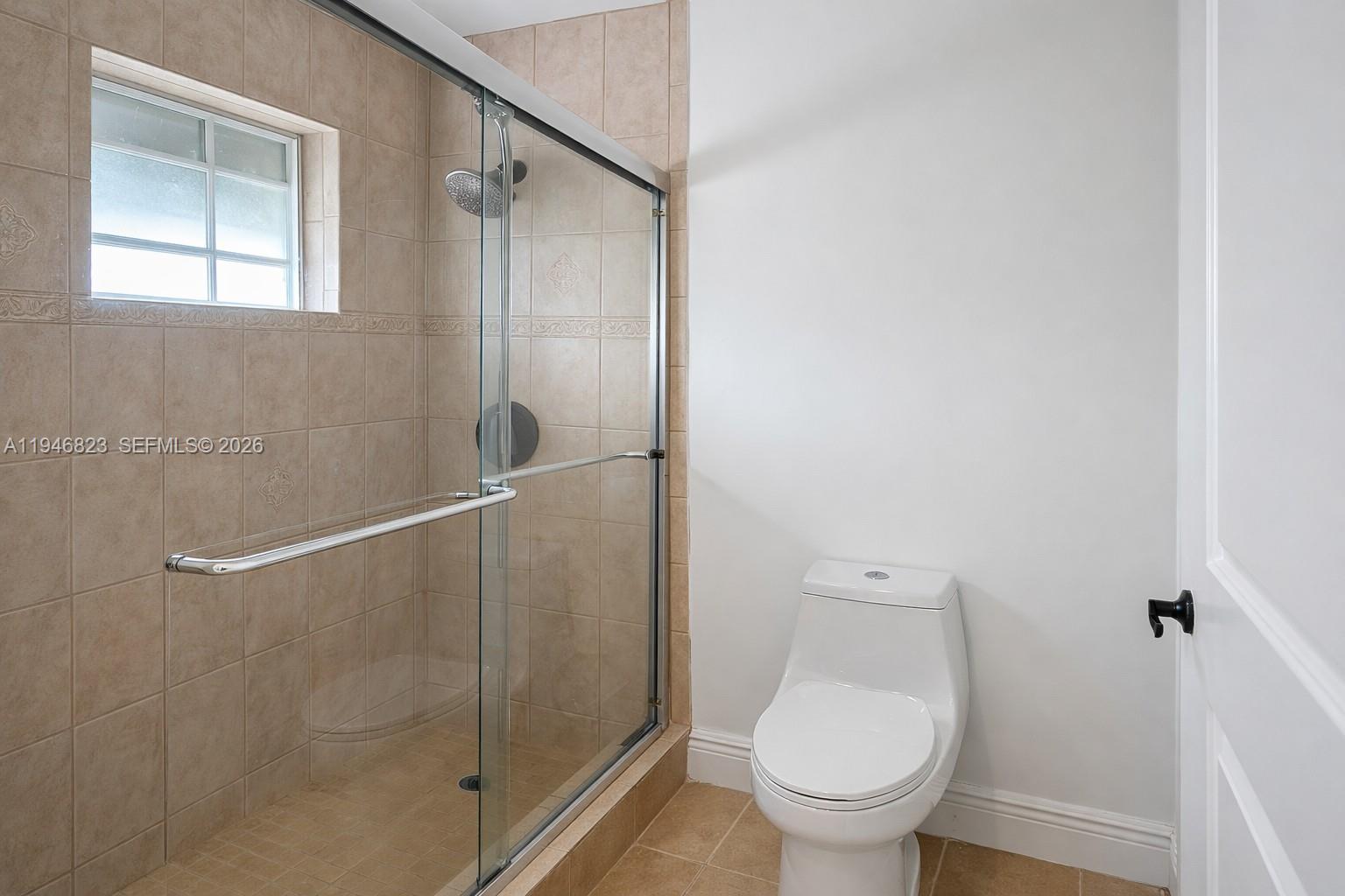 10923 West Okeechobee Road, Unit 201 Hialeah Gardens, FL 33018 - Photo 12 of 13 a bathroom with a toilet and a shower