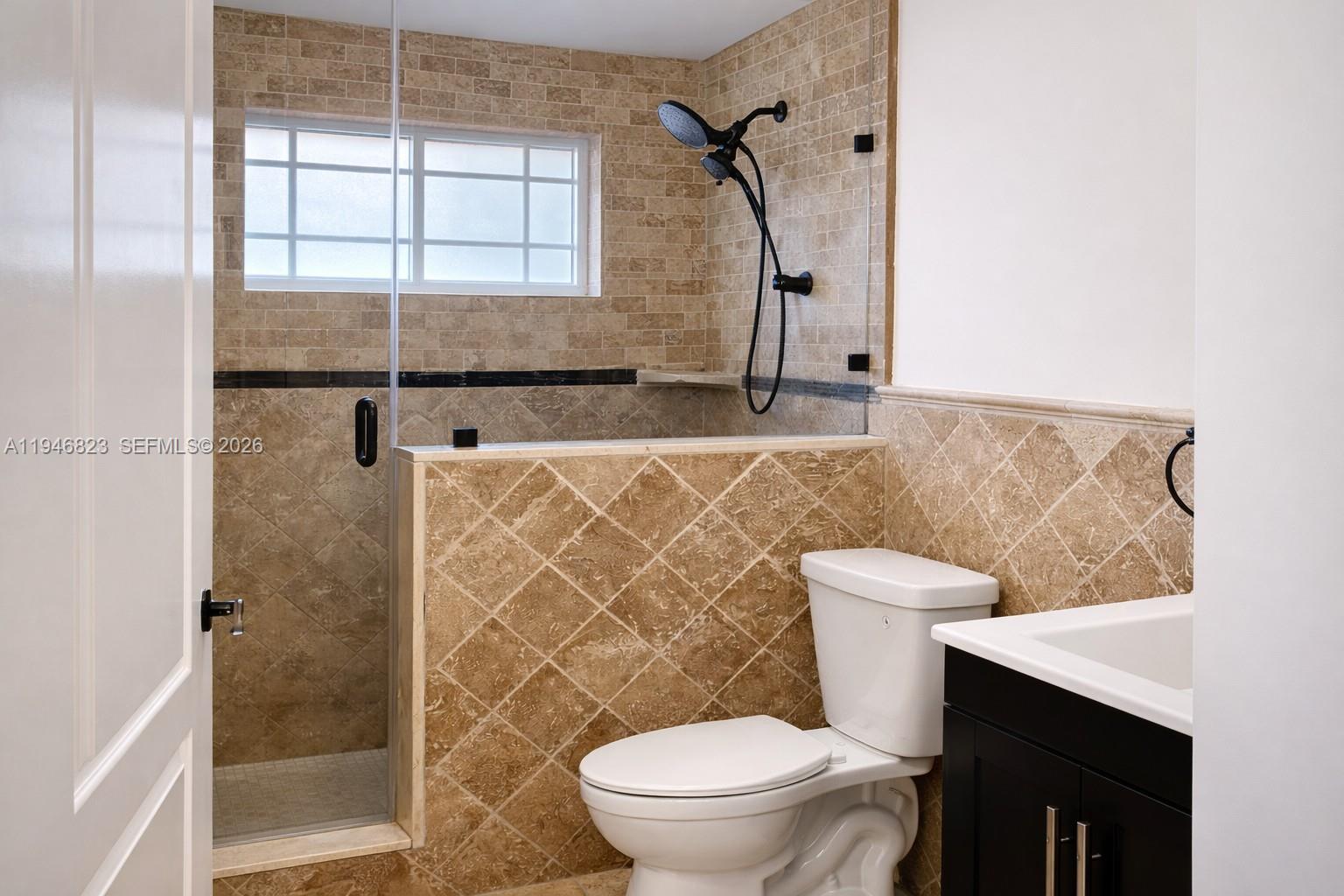 10923 West Okeechobee Road, Unit 201 Hialeah Gardens, FL 33018 - Photo 13 of 13 a bathroom with a toilet sink and shower