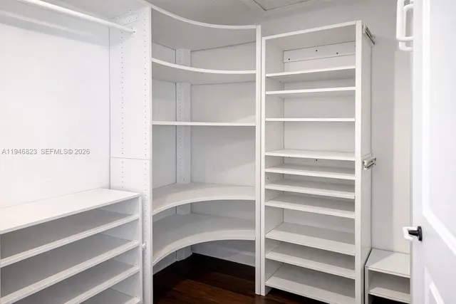 a view of walk in closet with empty racks