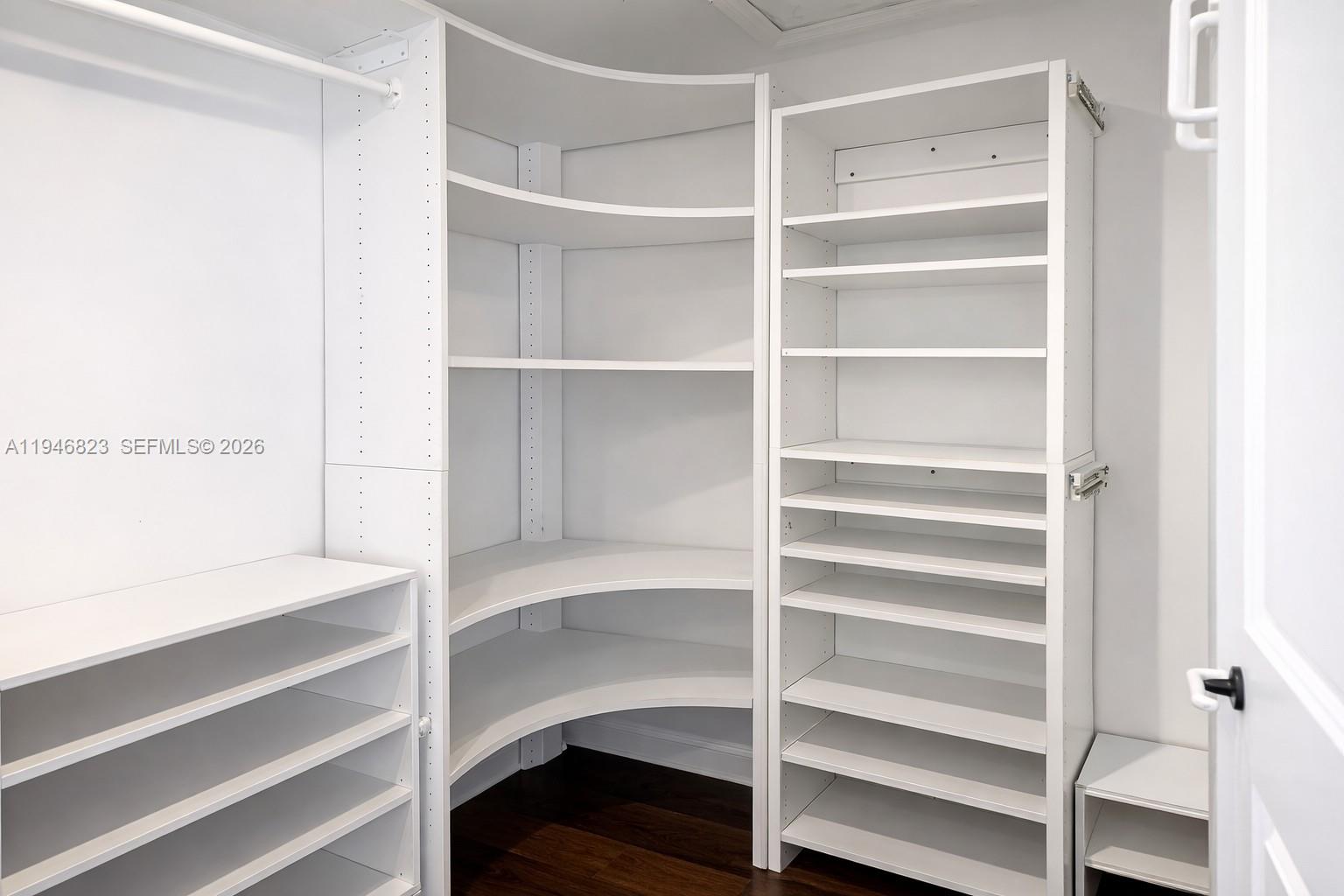 10923 West Okeechobee Road, Unit 201 Hialeah Gardens, FL 33018 - Photo 8 of 13 a view of walk in closet with empty racks