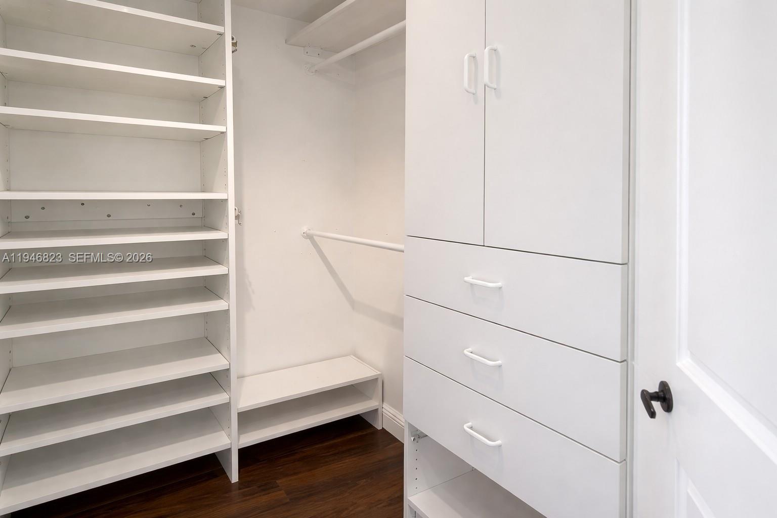 10923 West Okeechobee Road, Unit 201 Hialeah Gardens, FL 33018 - Photo 9 of 13 a view of walk in closet with empty racks