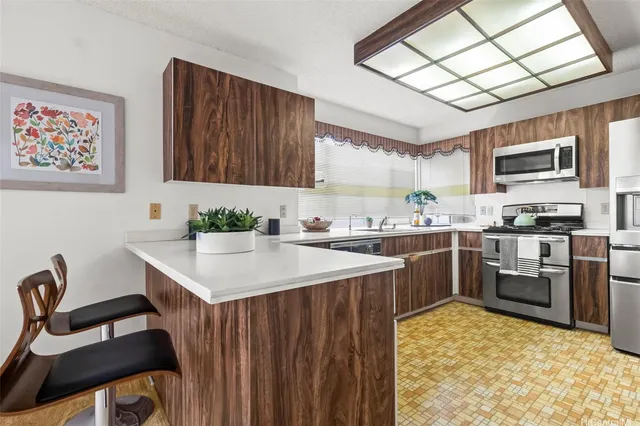 a kitchen with a sink cabinets and stainless steel appliances