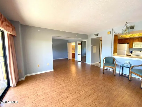 a view of a livingroom with furniture and a window