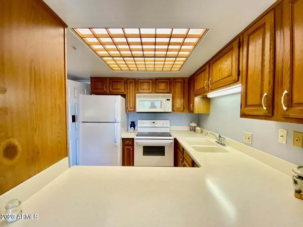 a kitchen with a sink a refrigerator and window