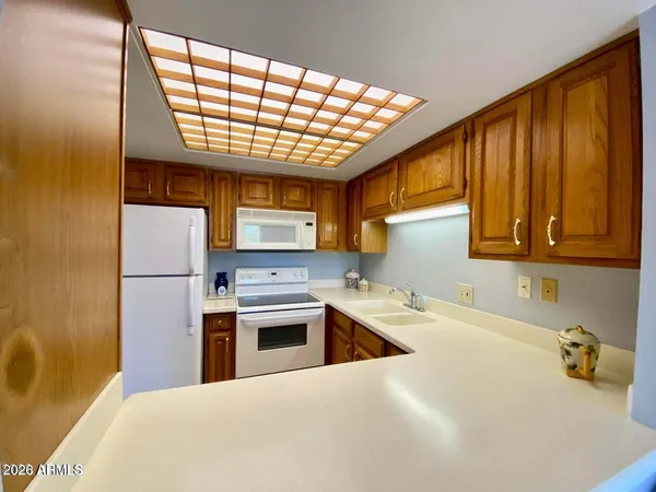 a kitchen with a sink a counter top space and stainless steel appliances