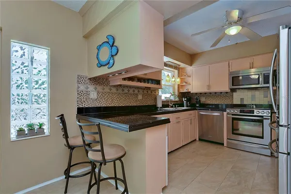 a kitchen with stainless steel appliances granite countertop a sink and a stove