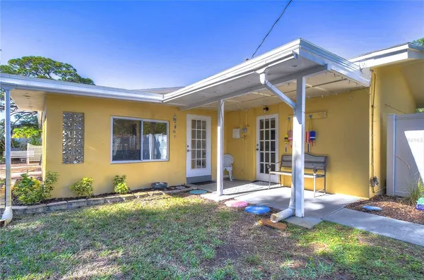 a view of a house with a yard and sitting area