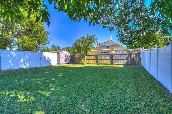 a view of a patio with table and chairs under an umbrella