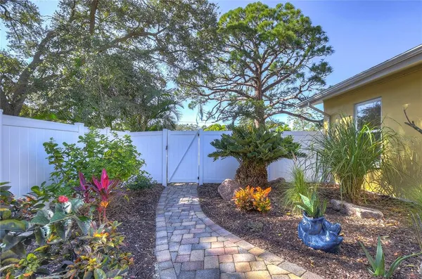 a view of a backyard with table and chairs under an umbrella