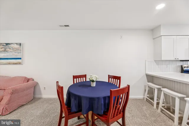a view of a room with furniture and wooden floor