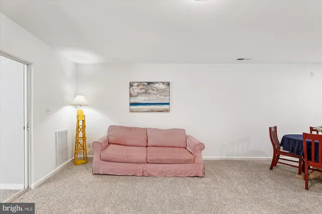 a living room with furniture and a dining table