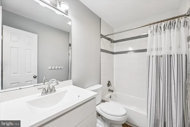 a bathroom with a sink mirror toilet and bathtub