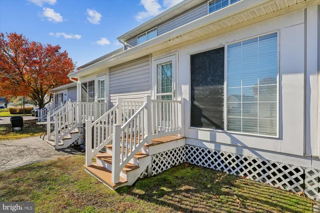 a view of a house with a wooden fence