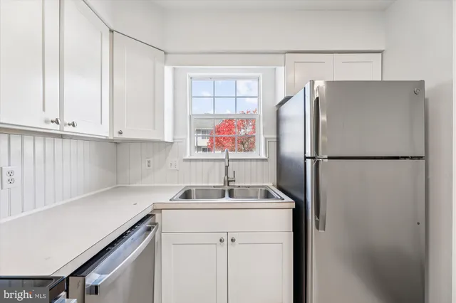 a kitchen with a refrigerator and a sink
