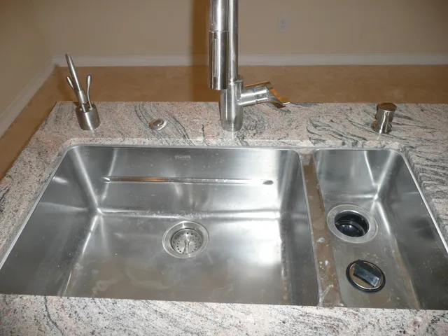 a kitchen with a refrigerator a stove and white cabinets