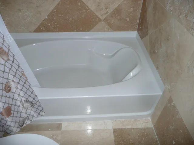 a bathroom with a bathtub and shower