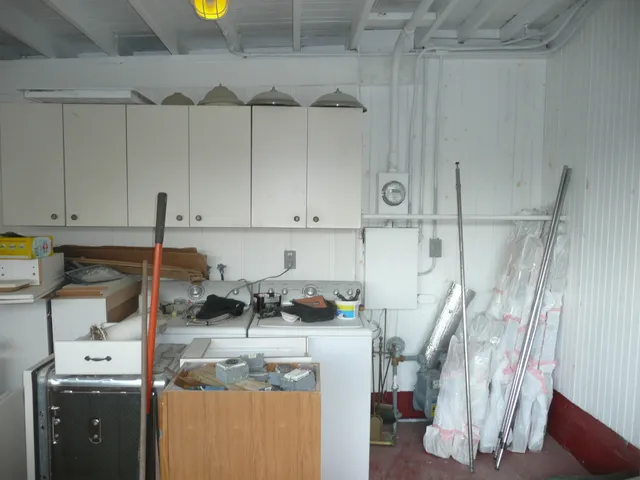 a kitchen with cabinets appliances and a sink