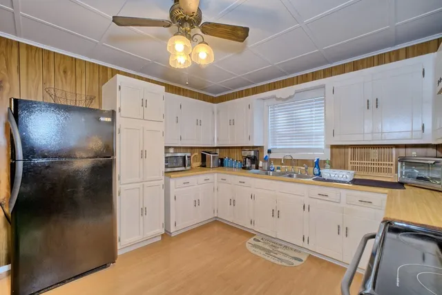 a bedroom with a bed and a ceiling fan