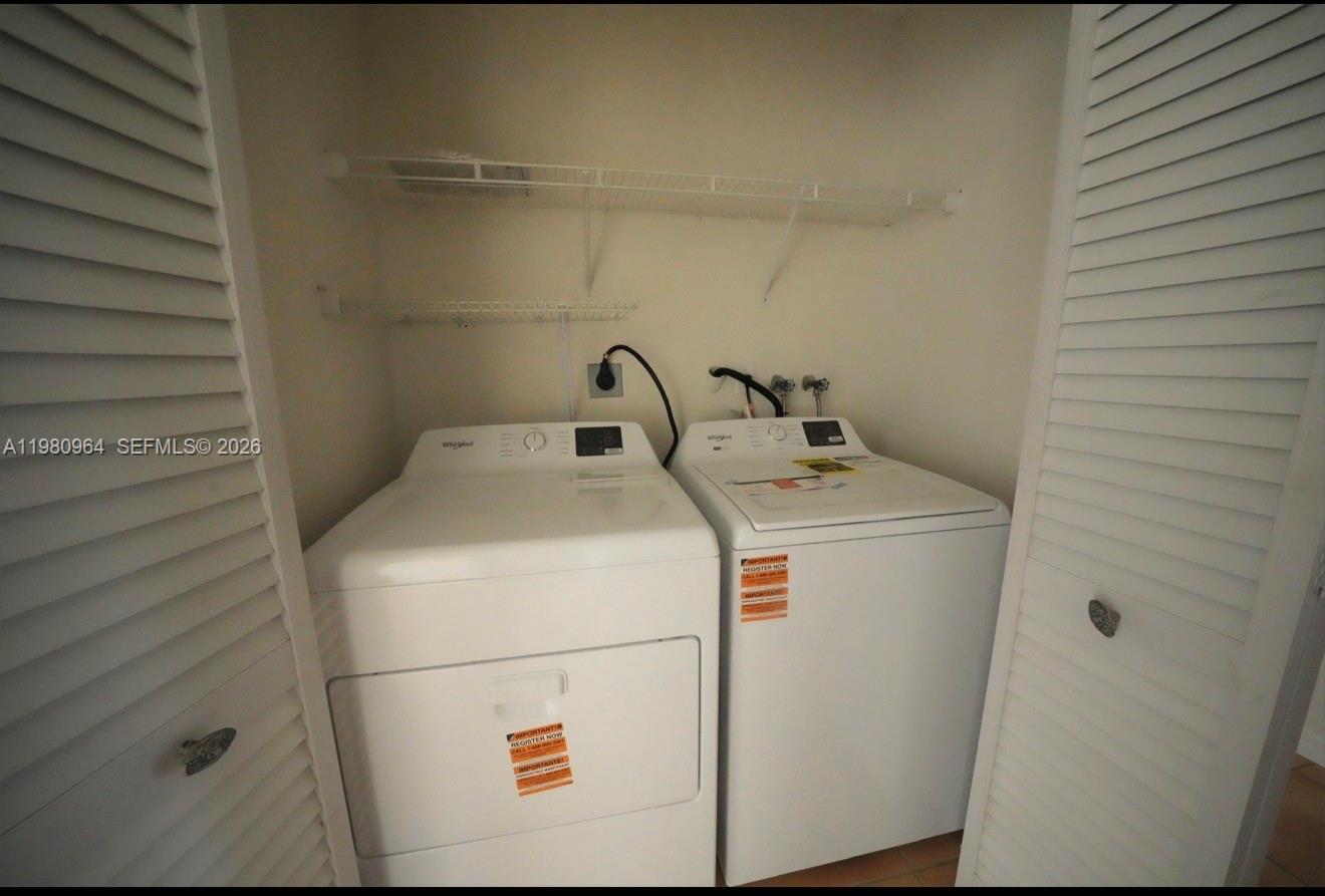 9921 Southwest 164th Court Miami, FL 33196 - Photo 15 of 20 a utility room with dryer and washer