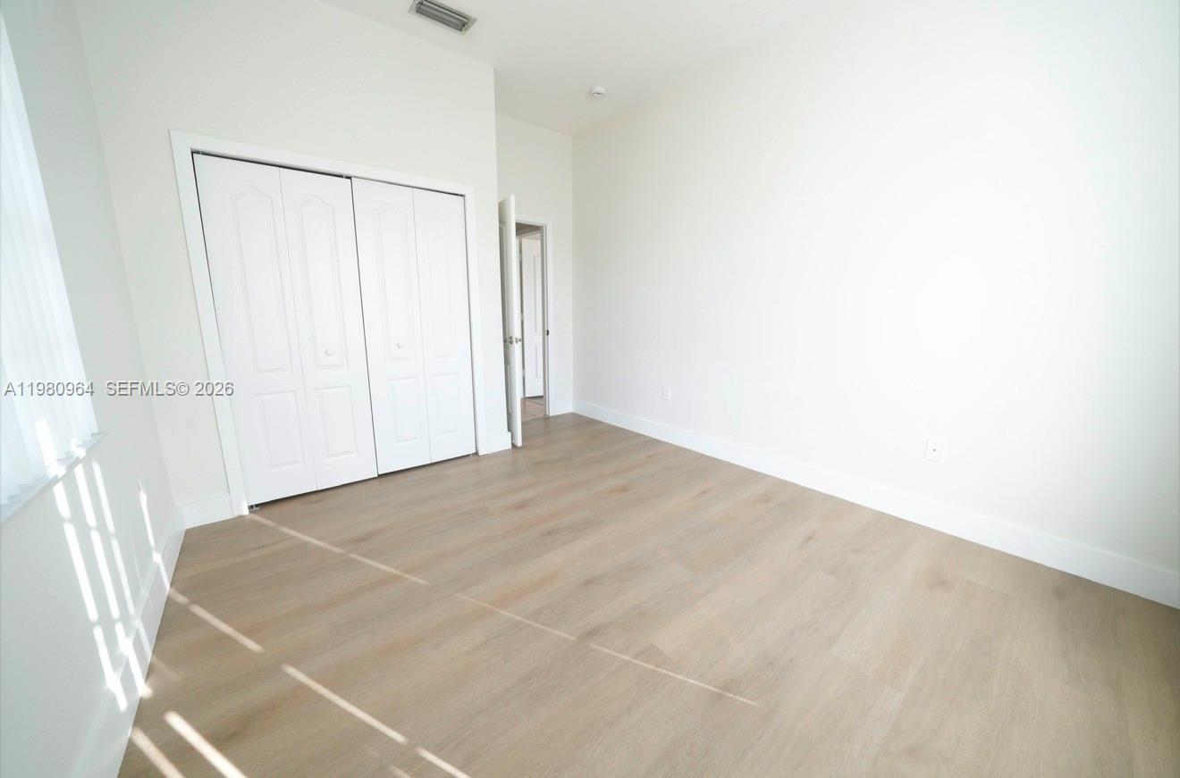 9921 Southwest 164th Court Miami, FL 33196 - Photo 16 of 20 a view of a room with an empty shelf