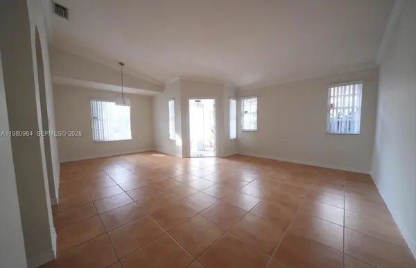 a view of an empty room with windows