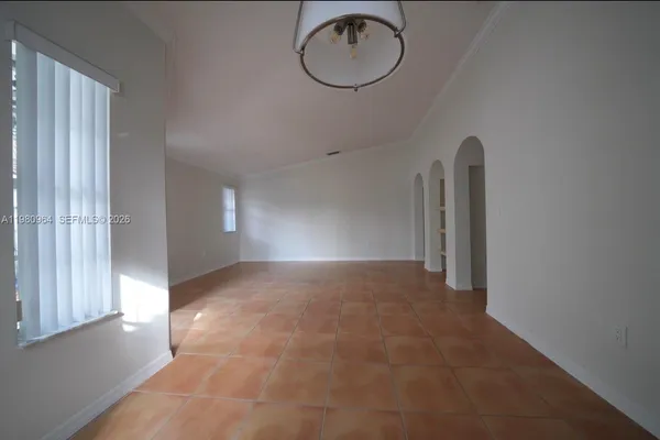 a view of a room with wooden floor and window