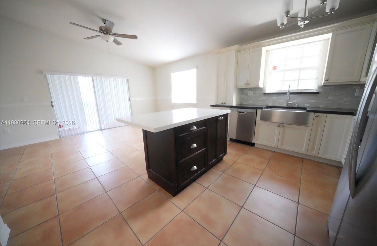 9921 Southwest 164th Court Miami, FL 33196 - Photo 7 of 20 a kitchen with a cabinets and window