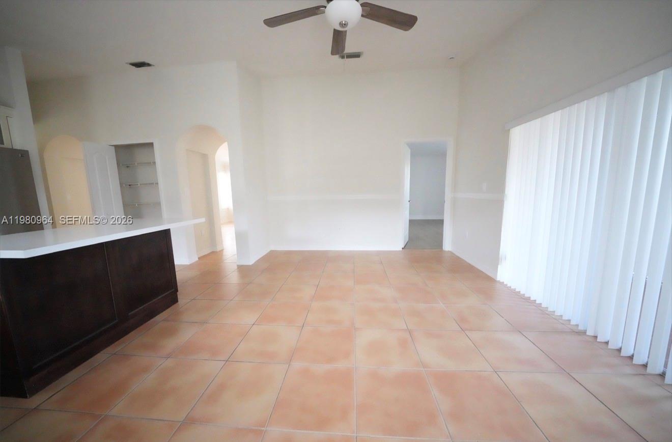 9921 Southwest 164th Court Miami, FL 33196 - Photo 8 of 20 a view of empty room with a fireplace and cabinet