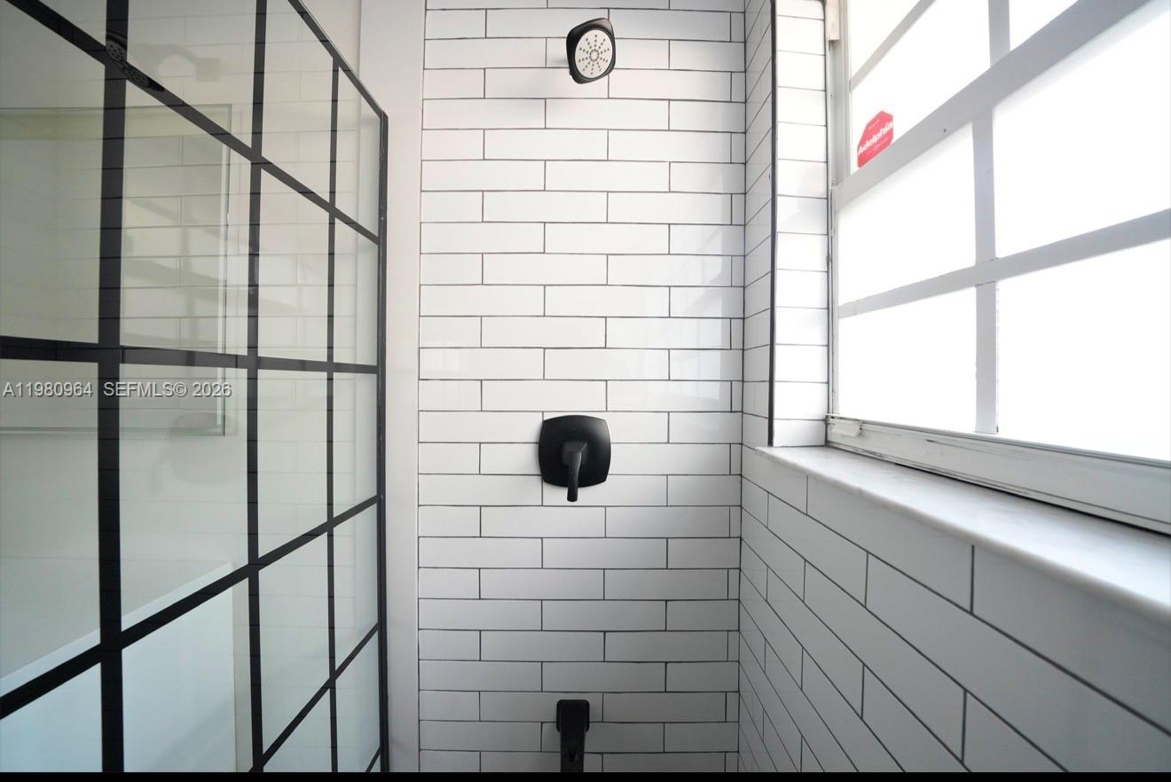 9921 Southwest 164th Court Miami, FL 33196 - Photo 10 of 20 a bathroom with a shower and a window
