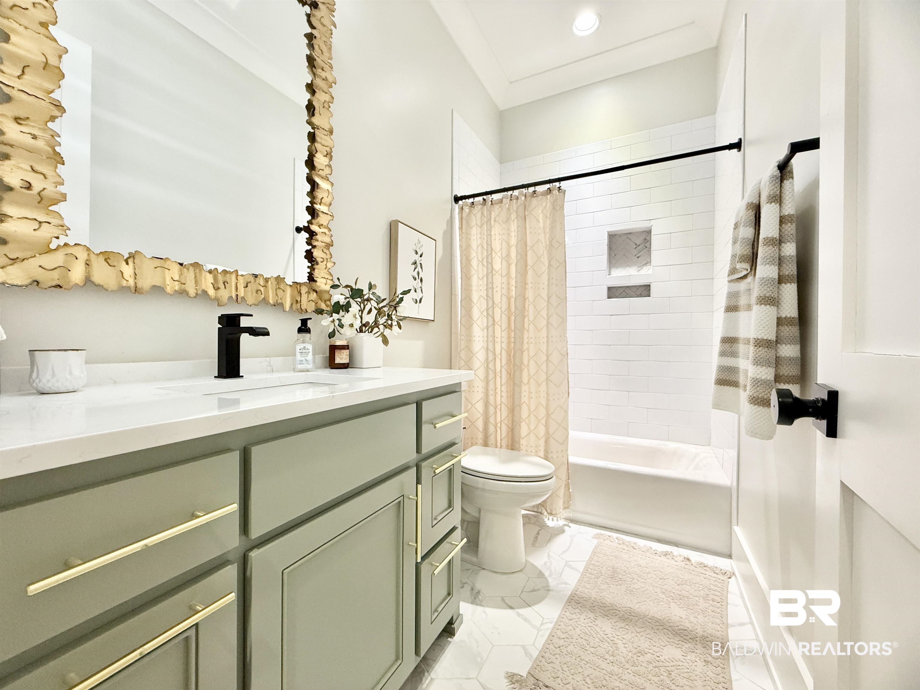 21767 Gallery Boulevard Fairhope, AL 36532 - Photo 23 of 74 Full bathroom with vanity, shower / bathtub combination with curtain, and marble look tile flooring