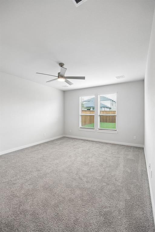 1460 Companero Street Haslet, TX 76052 - Photo 15 of 35 an empty room with windows and ceiling fan