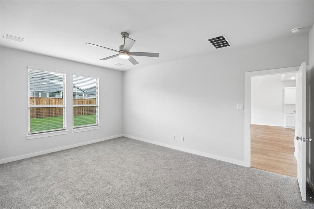 1460 Companero Street Haslet, TX 76052 - Photo 17 of 35 an empty room with windows and fan