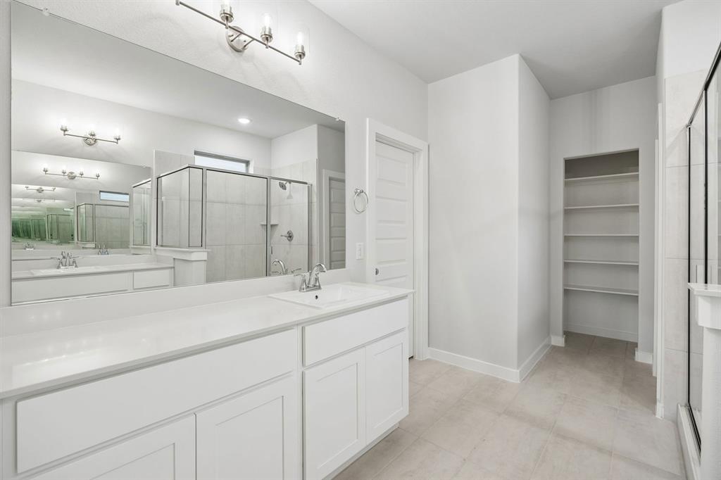 1460 Companero Street Haslet, TX 76052 - Photo 18 of 35 a bathroom with a sink and a mirror
