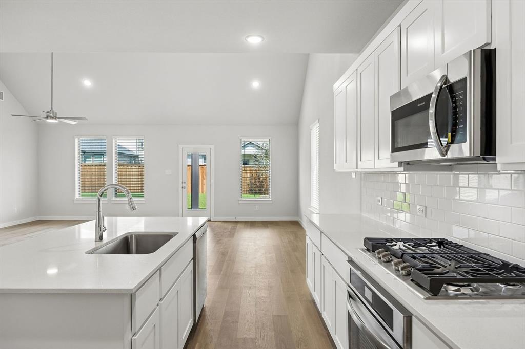1460 Companero Street Haslet, TX 76052 - Photo 8 of 35 a kitchen that has a sink stainless steel appliances and cabinets