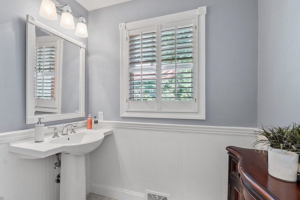 595 Salisbury Street Worcester, MA 01609 - Photo 16 of 41 a bathroom with a sink a mirror and a window