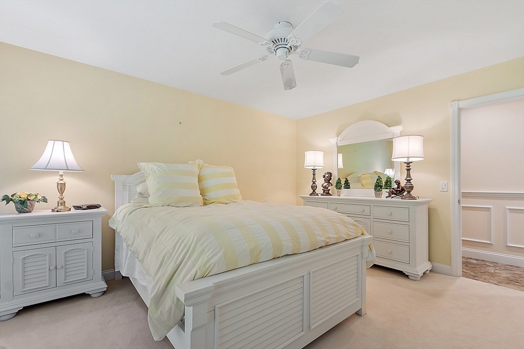 595 Salisbury Street Worcester, MA 01609 - Photo 23 of 41 a bedroom with a bed and a chandelier
