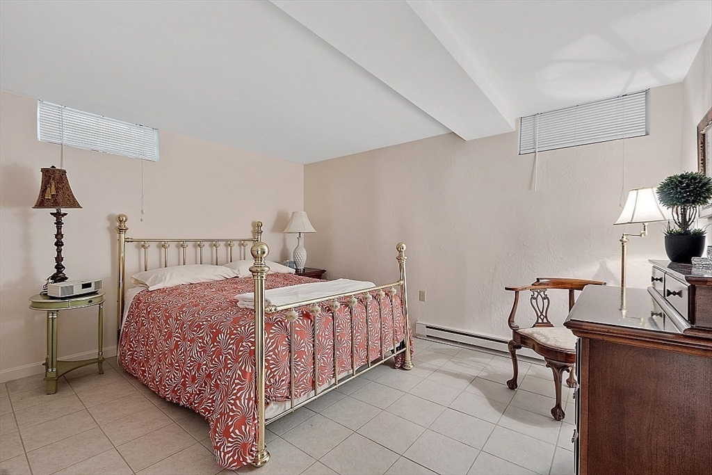 595 Salisbury Street Worcester, MA 01609 - Photo 28 of 41 a bedroom with a bed and a table in it