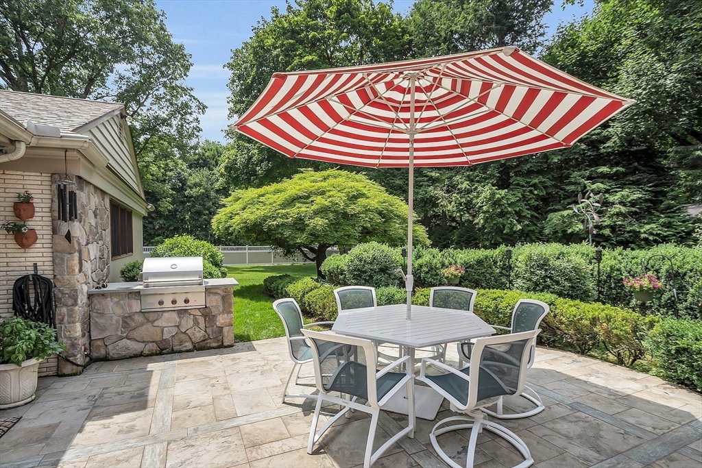 595 Salisbury Street Worcester, MA 01609 - Photo 32 of 41 a backyard of a house with a garden and outdoor seating